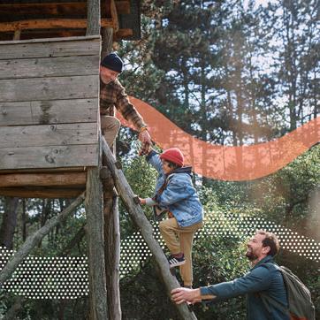 一个男孩和他的父亲和祖父一起爬树屋